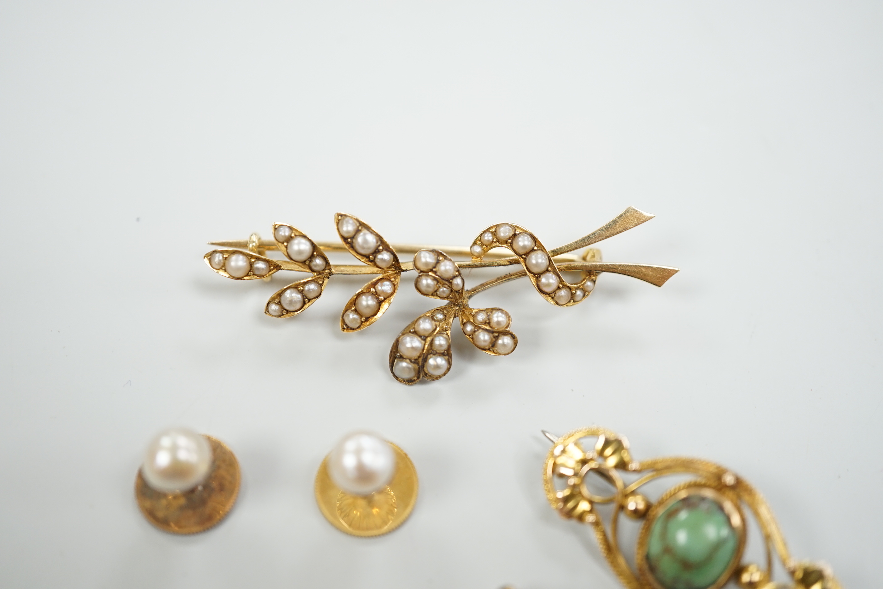 An Edwardian 15ct and seed pearl cluster set spray brooch, 47mm, a 15ct and four stone turquoise set brooch, one other yellow meta and turquoise brooch and a pair of 9ct and cultured pearl set dress studs.